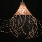 a conical, rattan chandelier with looping fringe sticking out in all directions from the bottom edge of the chandelier