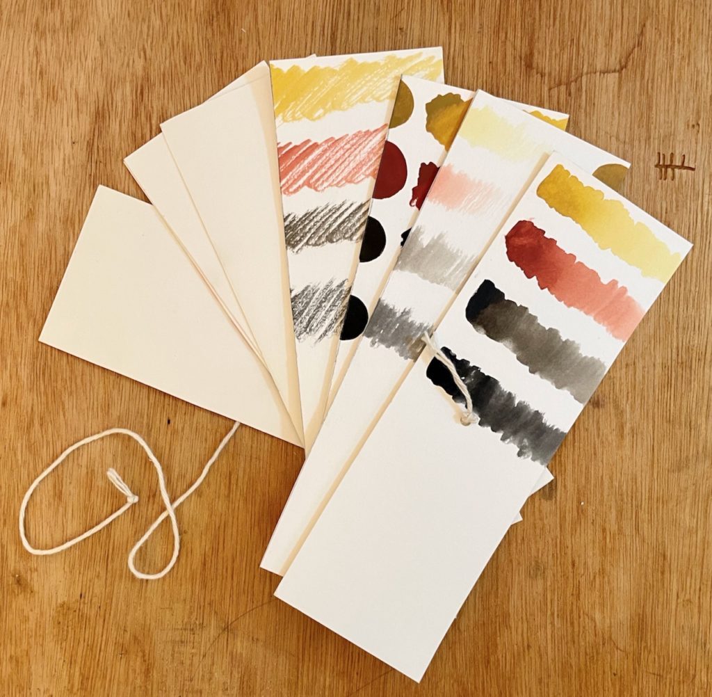 Pothi book made from a sheet of watercolor paper with four earth tone color swatches on it